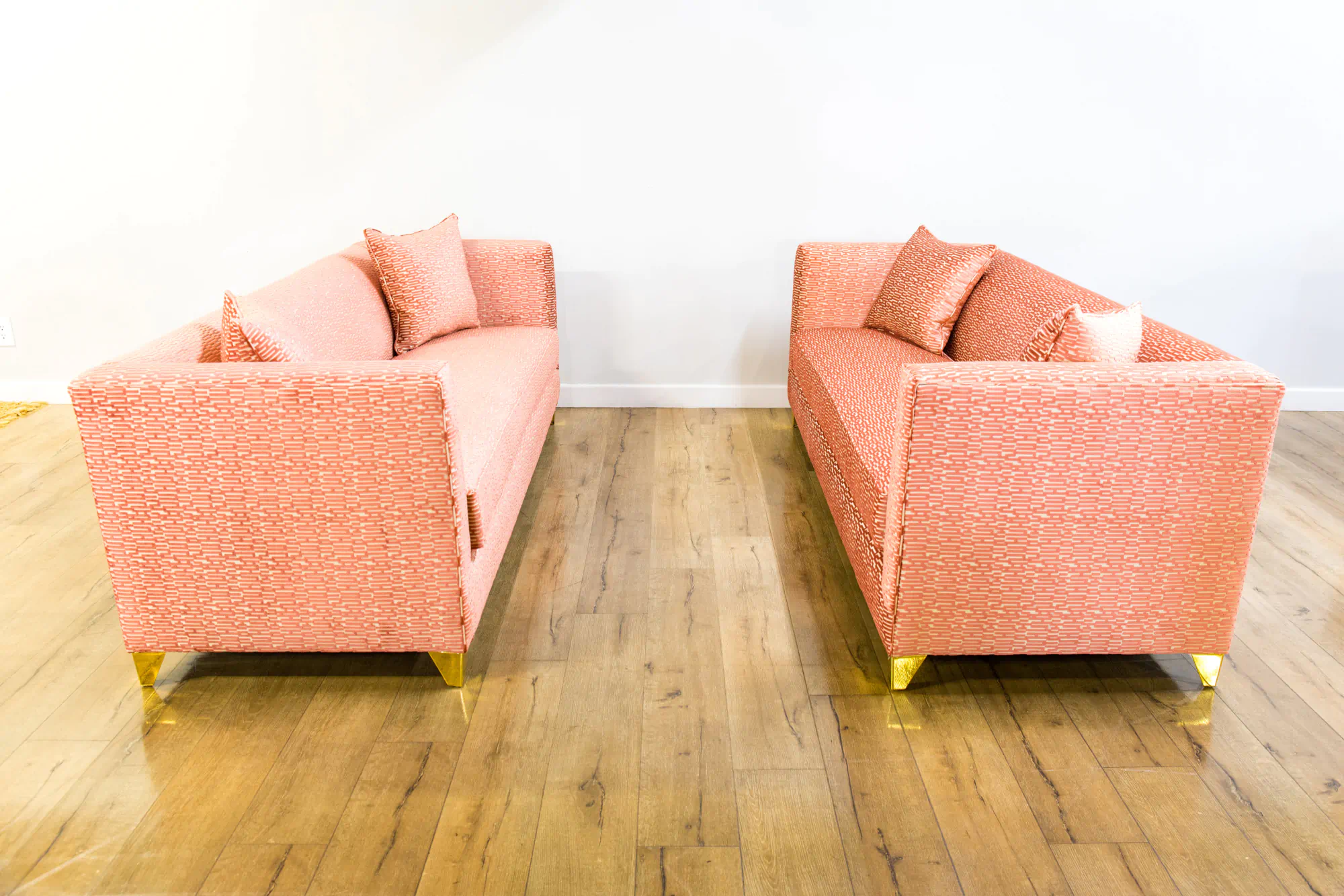 2 salmon color sofas