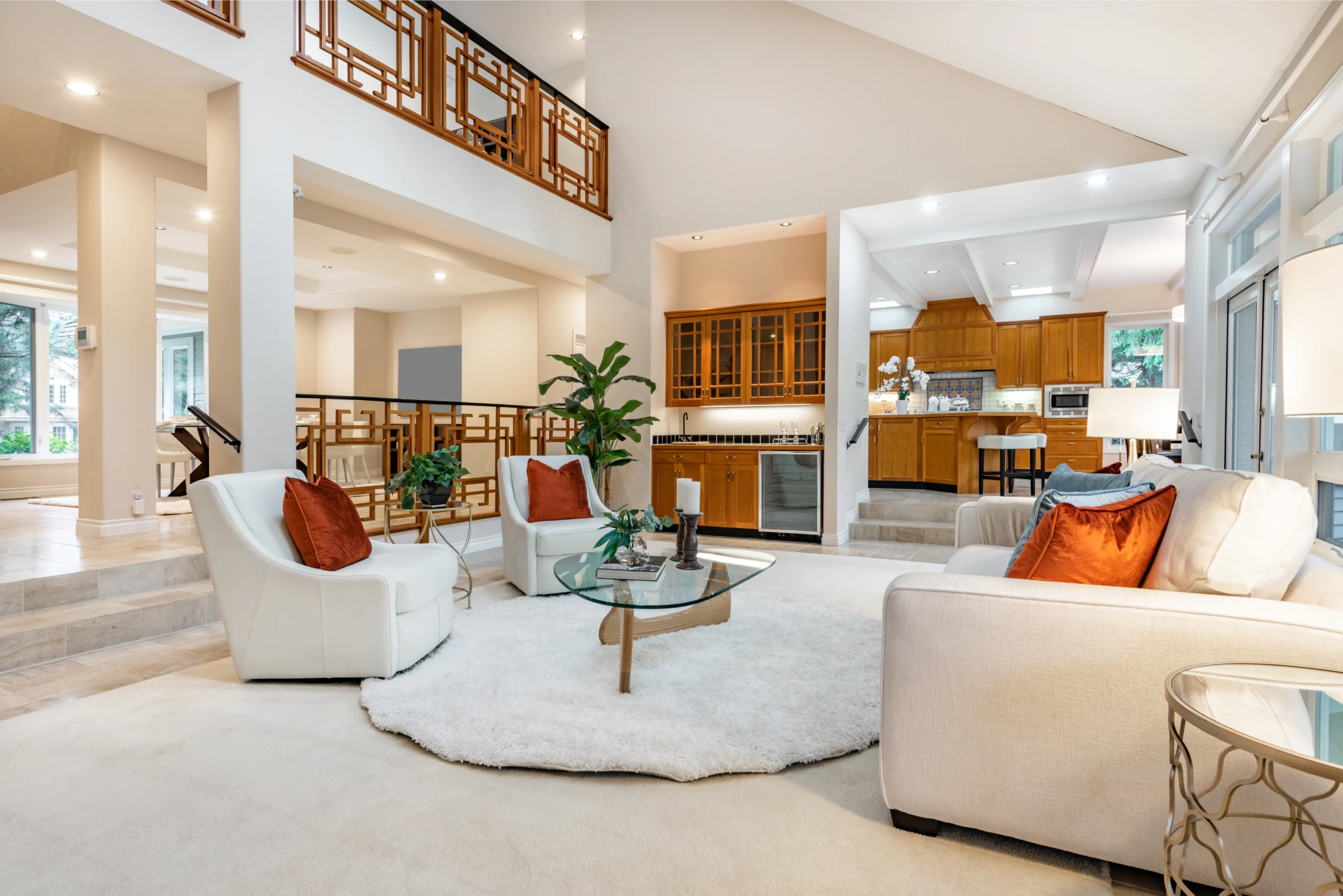 Mid century craftsman house interior living room foyer home office with wood panel walls staircase creative wooden railings stone fireplace in warm white tones and orange accent colors