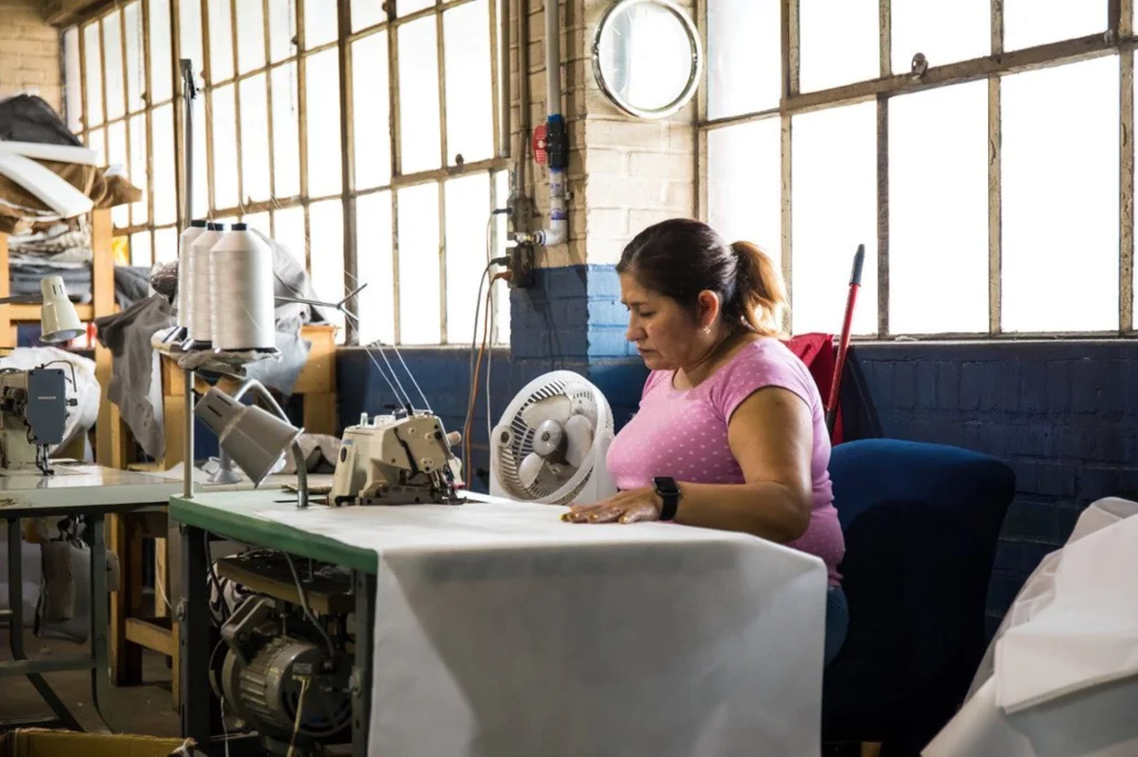 Woman crafting furniture in the Living Designs Furniture factory.