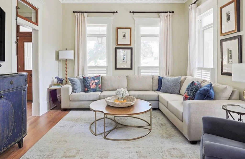 Custom light gray sectional in neutral living room.
