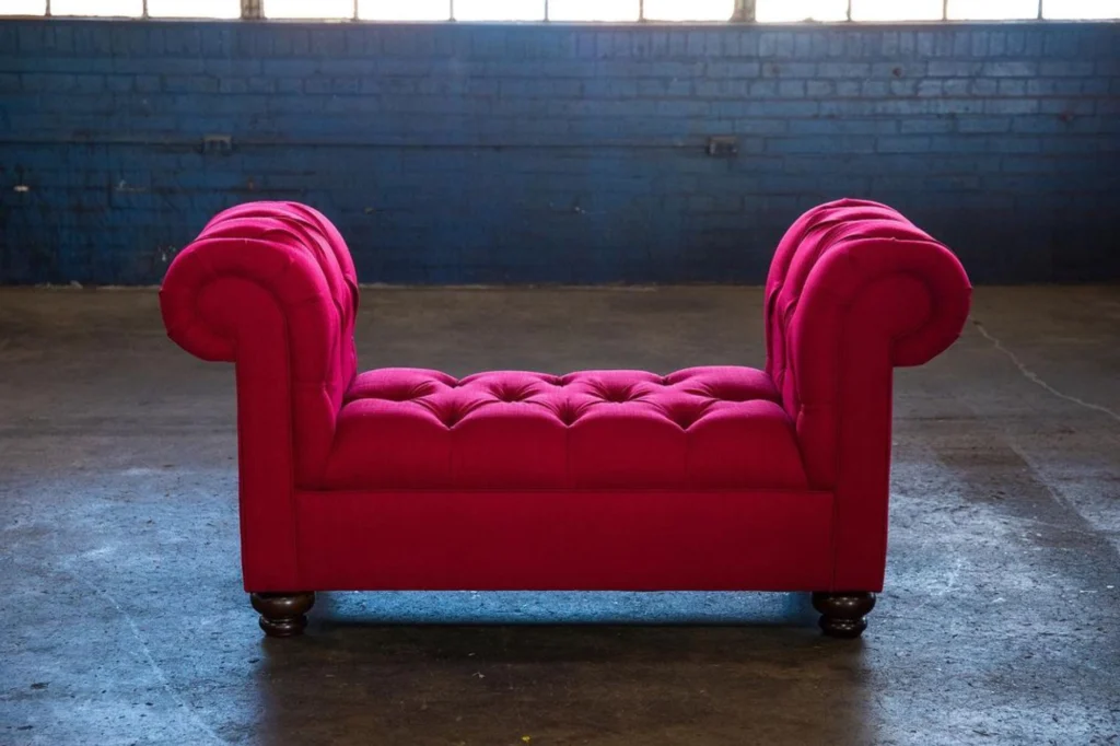 Bright red tufted bench made by Living Designs Furniture.