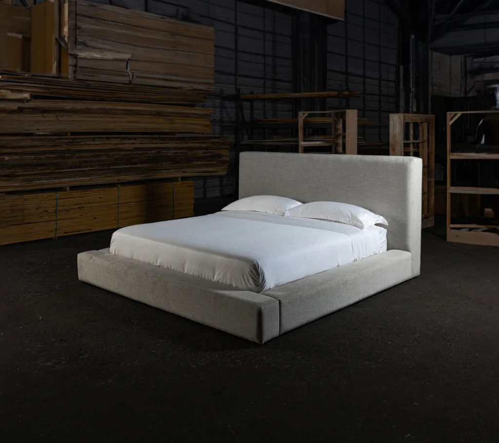 upholstered bed in dark warehouse
