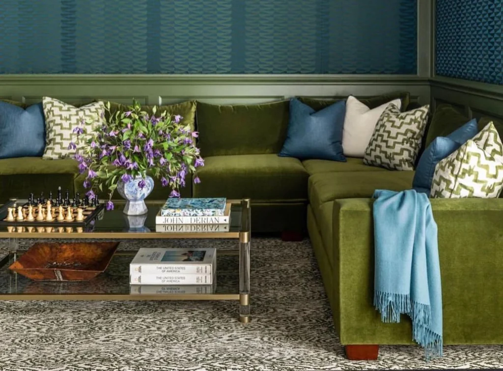 Custom olive green couch styled with blue and white accents made by Living Designs Furniture.