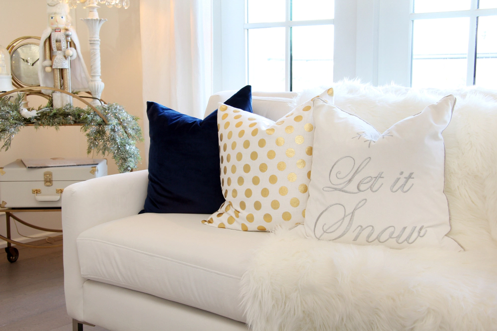 Festive throw pillows that say “let it snow” with other patterns.