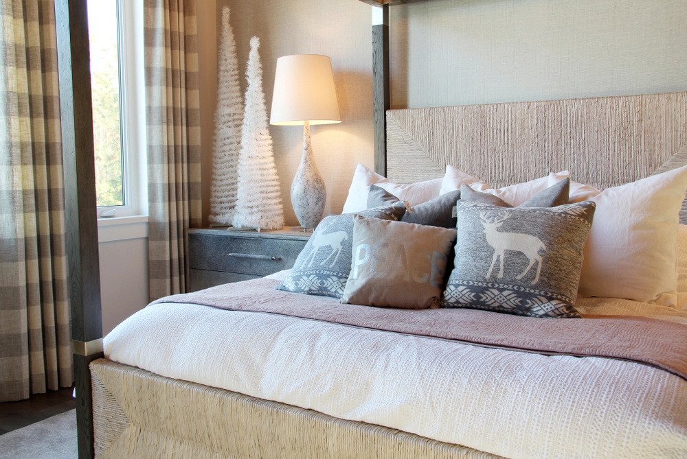 Bedroom with holiday throw pillows and neutral Christmas decor.