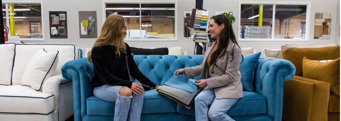 Women discussing fabric choices on an LDF sofa